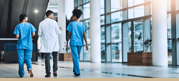 A Florida doctor and two nurses walking through a hospital lobby