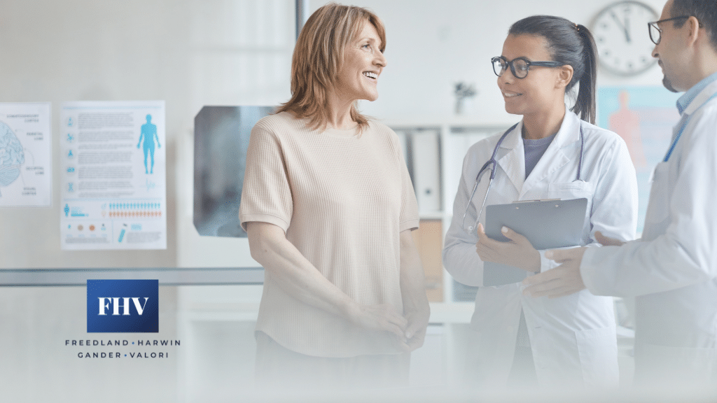 Female patient talking to two medical professionals at a doctors office