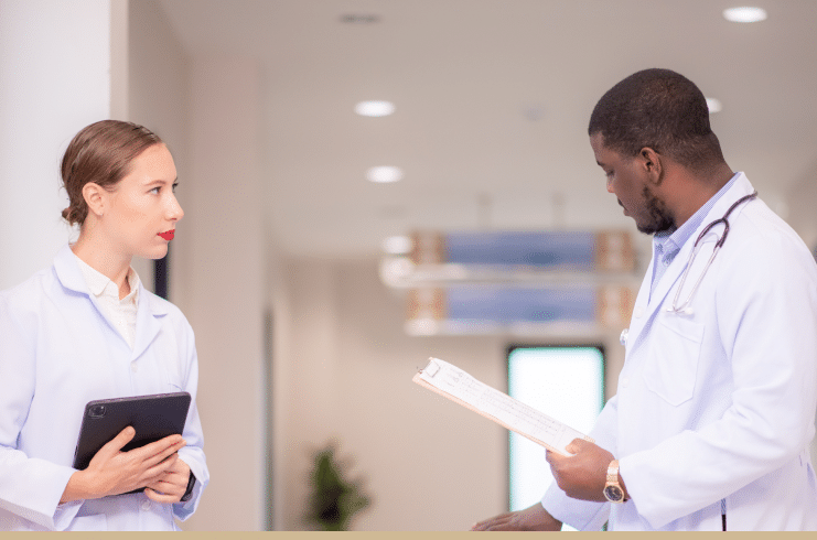 A doctor discussing a patient's case with the nurse.