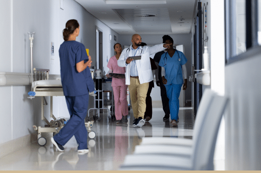 Doctors and nurses walking through Bethesda hospital hallway.