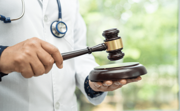 Close up of a doctor holding a gavel